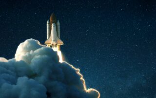 Space rocket launches into space against a starry blue sky. Image: iStock.com/Ales Utovko