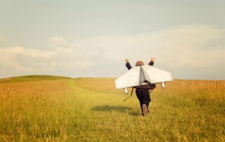 Young Business Boy Wearing Jetpack in field. Photo: iStock.com/Rich Vintage