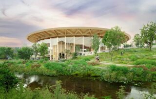 World of Volvo’s modern exterior, surrounded by nature with a river going by in the foreground.